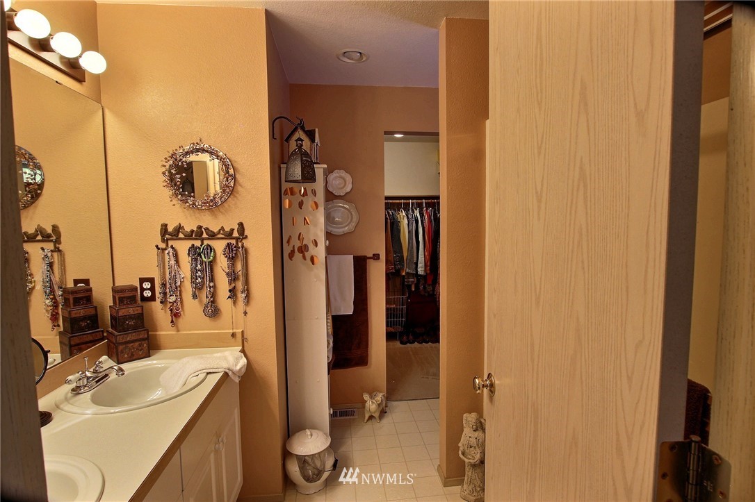 26412 231st Place Southeast Maple Valley, WA 98038 - Photo 10 of 18 a bathroom with a sink vanity granite tub and shower