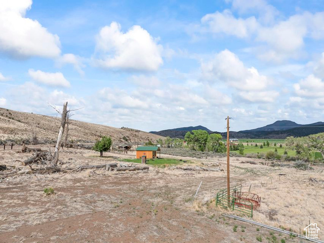 1054 East Jakes Pl Road Fremont, UT 84747 - Photo 18 of 18 View of yard featuring a view of countryside, a mountain view, and an outdoor structure