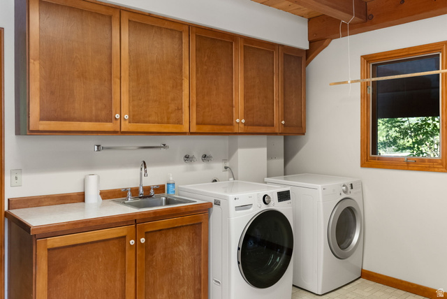 435 Canyon Road Millville, UT 84326 - Photo 23 of 113 Laundry room featuring wood cabinetry, integrated utility sink, and wood-beam ceiling details
