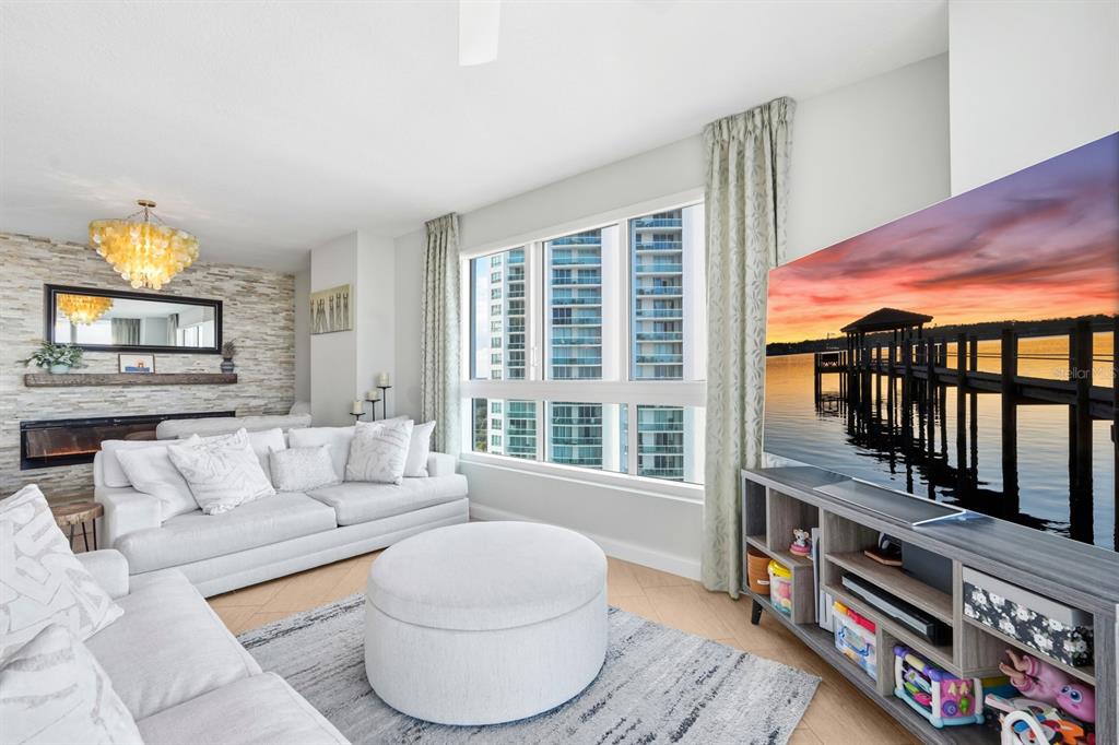 231 Riverside Drive, Unit 1702 Holly Hill, FL 32117 - Photo 13 of 74 a living room with furniture and a floor to ceiling window