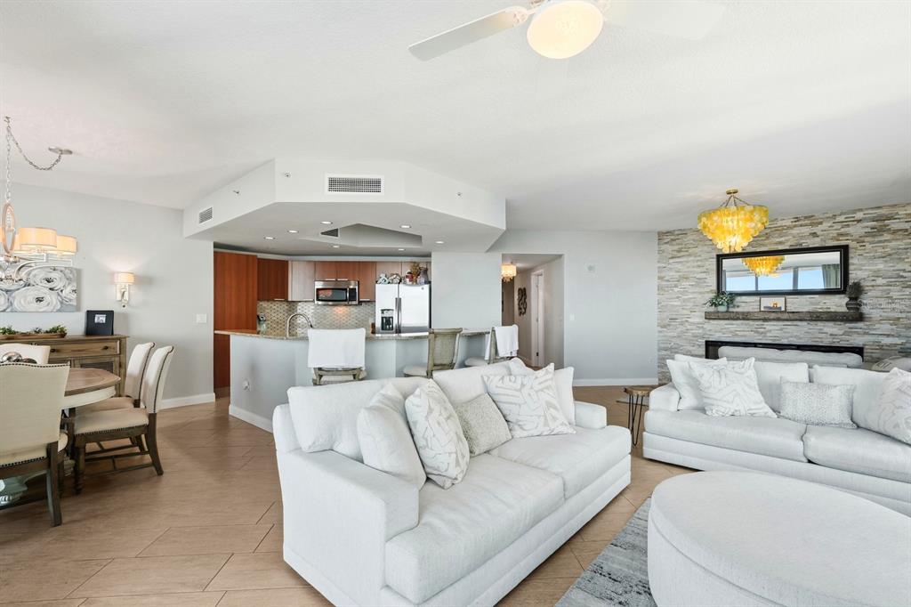 231 Riverside Drive, Unit 1702 Holly Hill, FL 32117 - Photo 14 of 74 a living room with furniture and a chandelier