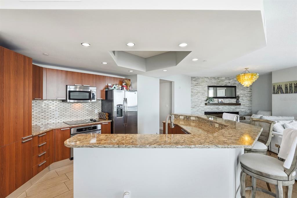 231 Riverside Drive, Unit 1702 Holly Hill, FL 32117 - Photo 17 of 74 a kitchen with stainless steel appliances granite countertop a sink and a refrigerator