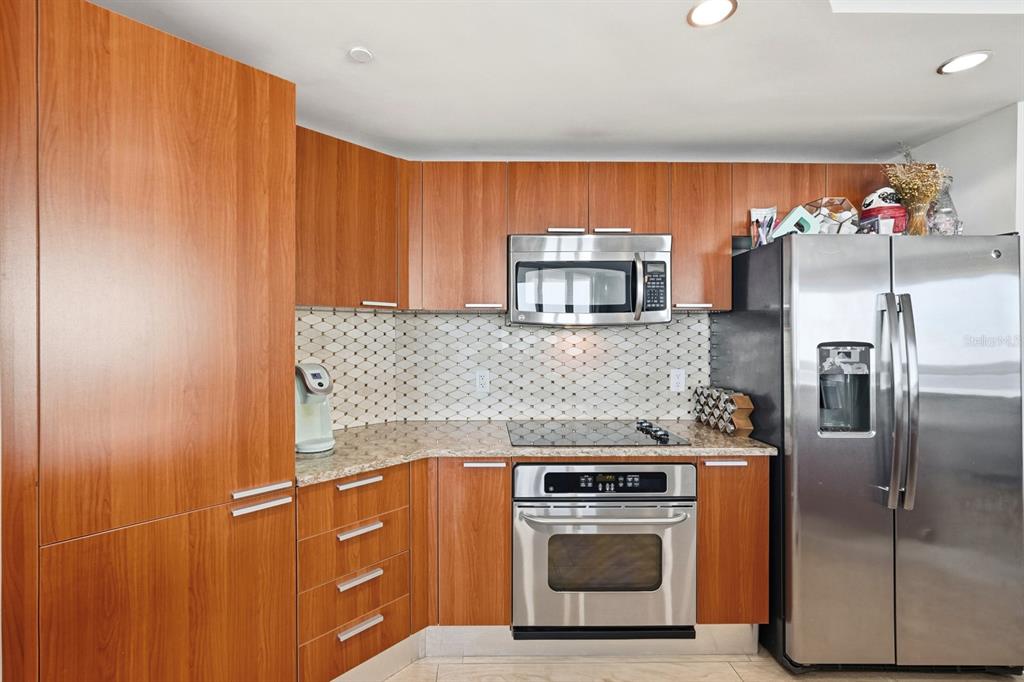 231 Riverside Drive, Unit 1702 Holly Hill, FL 32117 - Photo 20 of 74 a kitchen with stainless steel appliances granite countertop a refrigerator and a stove
