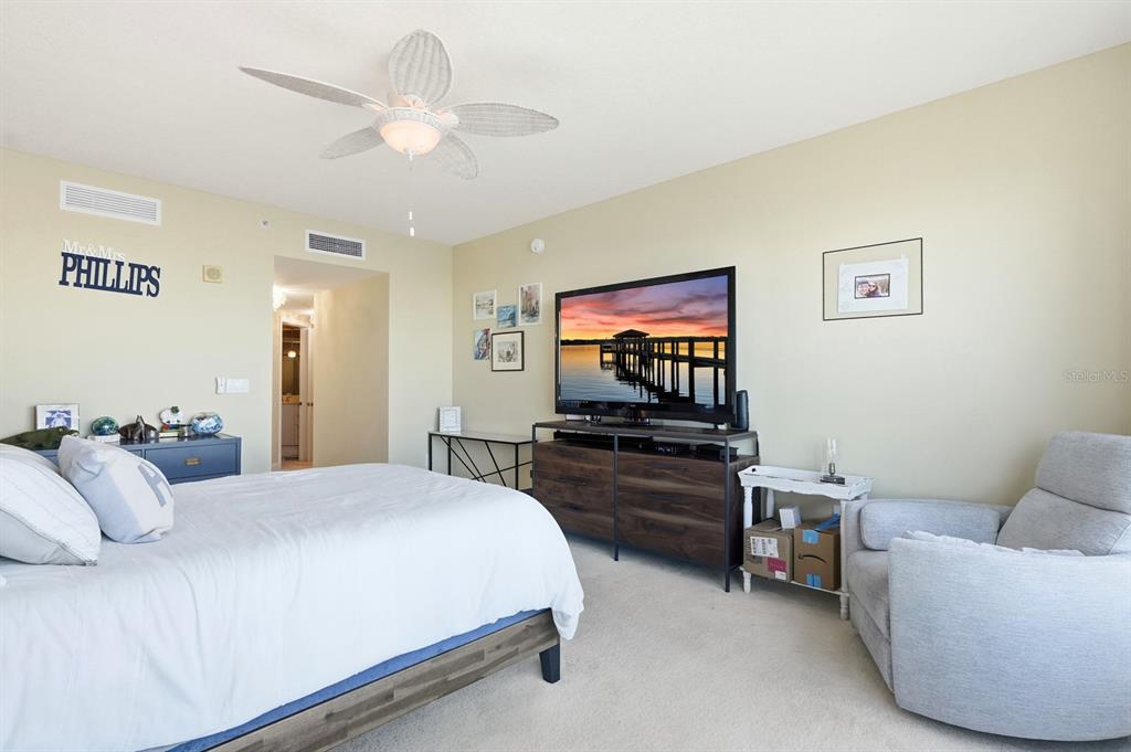 231 Riverside Drive, Unit 1702 Holly Hill, FL 32117 - Photo 24 of 74 a bedroom with a bed and a flat screen tv