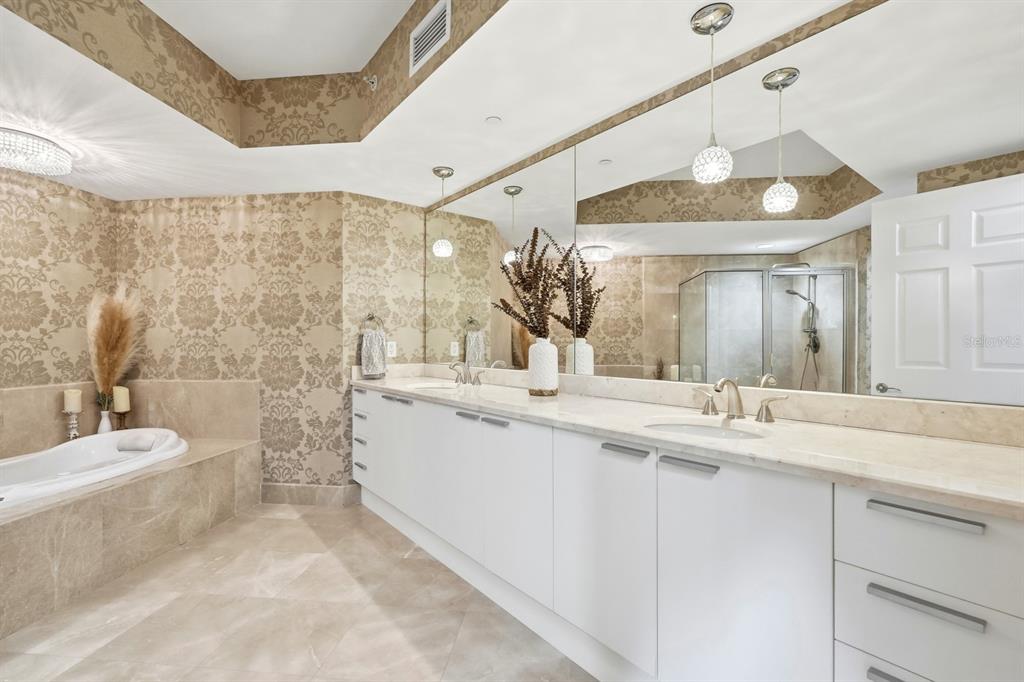 231 Riverside Drive, Unit 1702 Holly Hill, FL 32117 - Photo 27 of 74 a bathroom with a granite countertop sink mirror and a bathtub