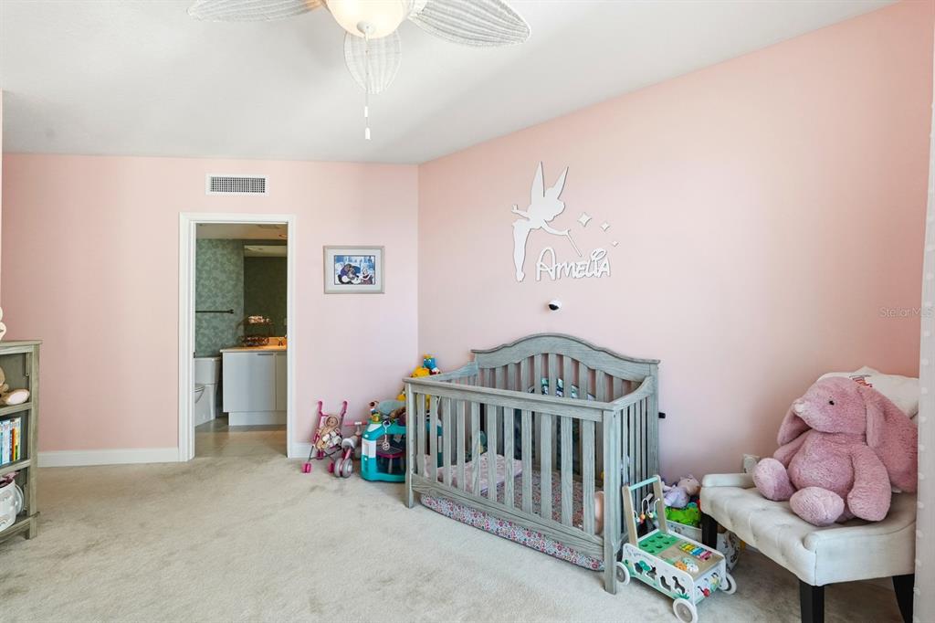 231 Riverside Drive, Unit 1702 Holly Hill, FL 32117 - Photo 31 of 74 a bedroom with furniture and baby crib
