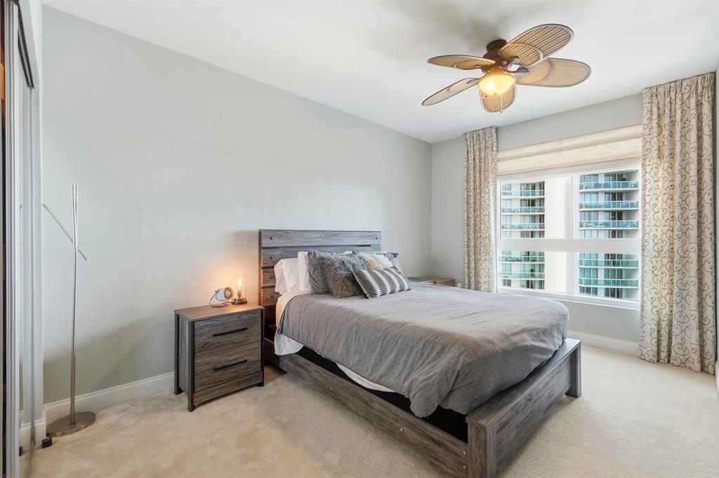 231 Riverside Drive, Unit 1702 Holly Hill, FL 32117 - Photo 33 of 74 a bedroom with a bed lamp and a window