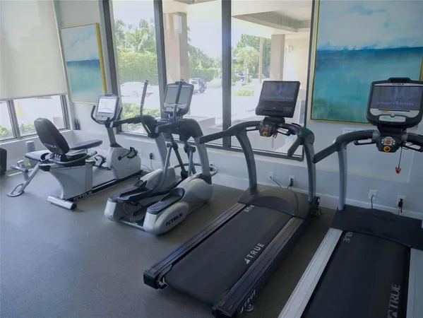 a room with gym equipment and a large window