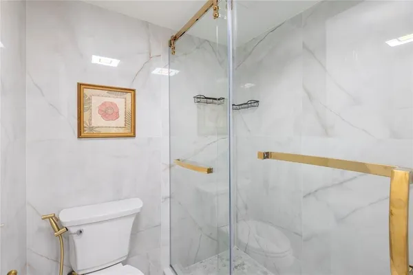 a bathroom with a shower and toilet
