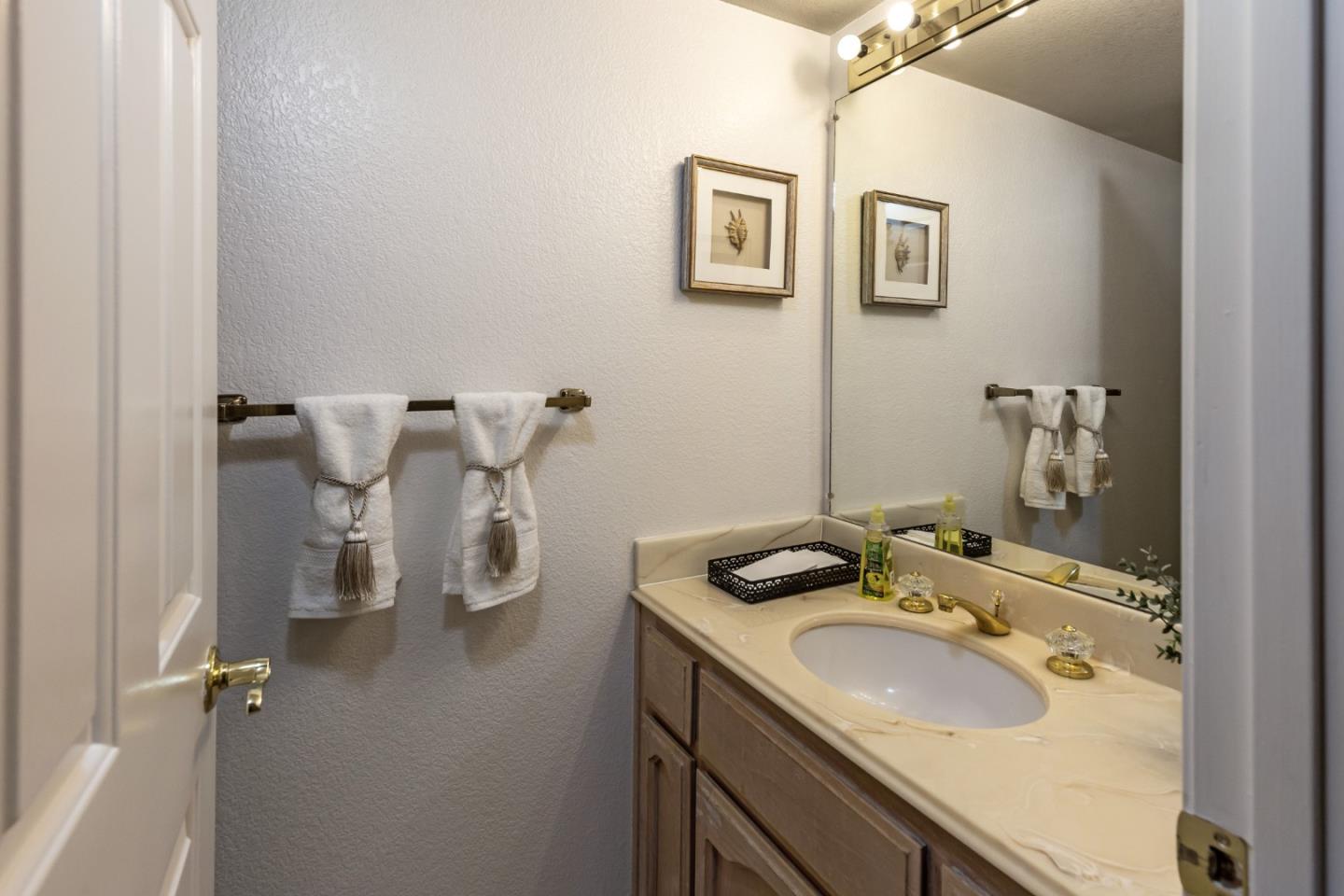 2372 Dubois Street Milpitas, CA 95035 - Photo 20 of 30 a bathroom with a granite countertop sink and a mirror