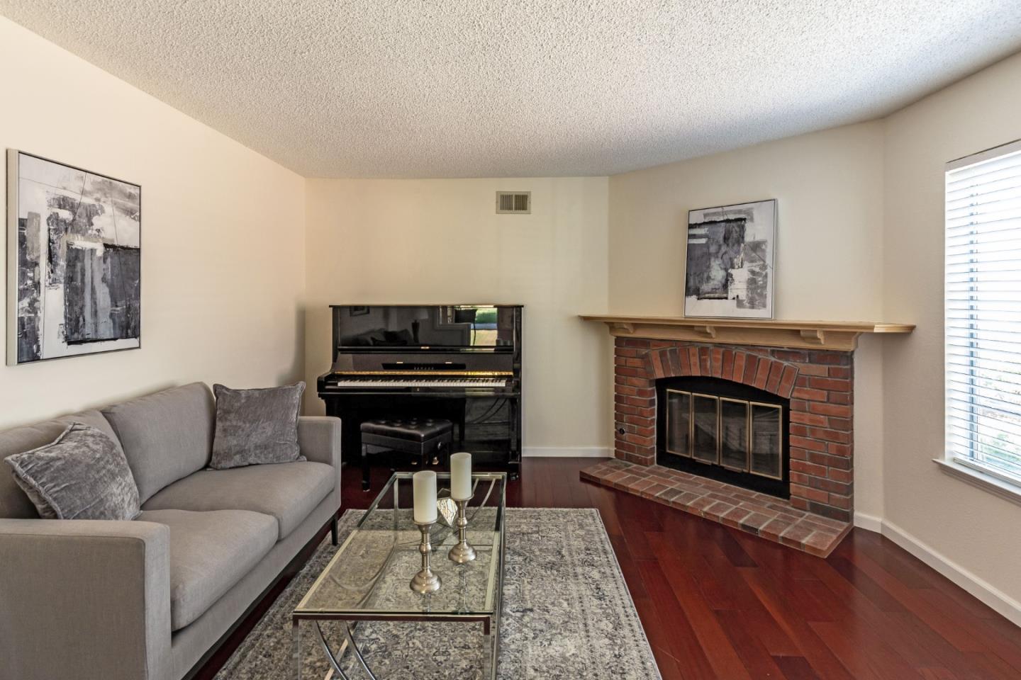 2372 Dubois Street Milpitas, CA 95035 - Photo 5 of 30 a living room with furniture a fireplace and a window