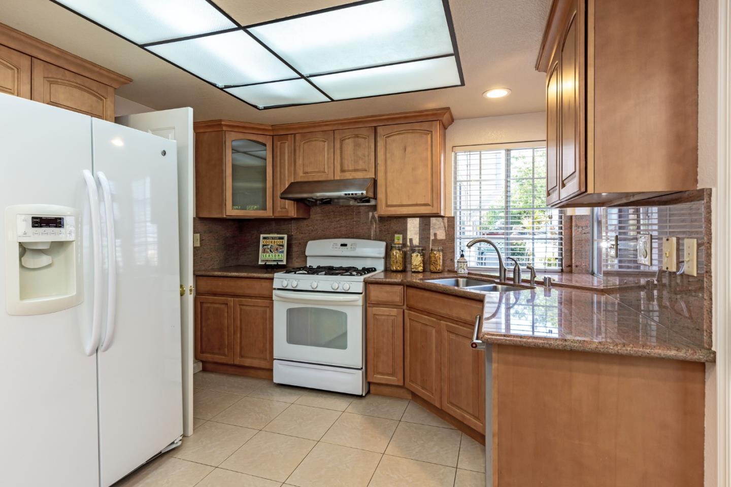 2372 Dubois Street Milpitas, CA 95035 - Photo 9 of 30 a kitchen with stainless steel appliances granite countertop a refrigerator and a sink