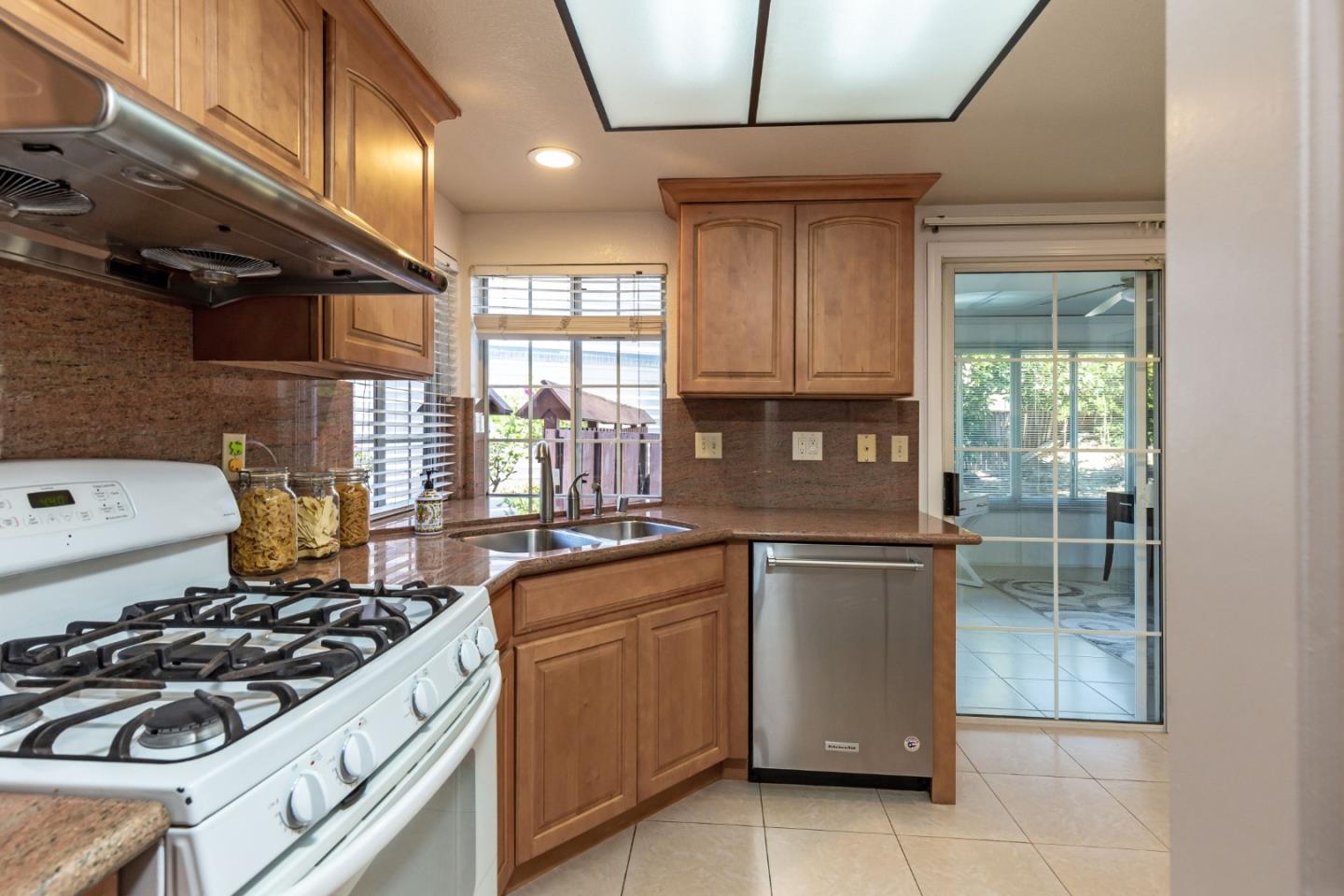 2372 Dubois Street Milpitas, CA 95035 - Photo 10 of 30 a kitchen with a stove a sink and a microwave