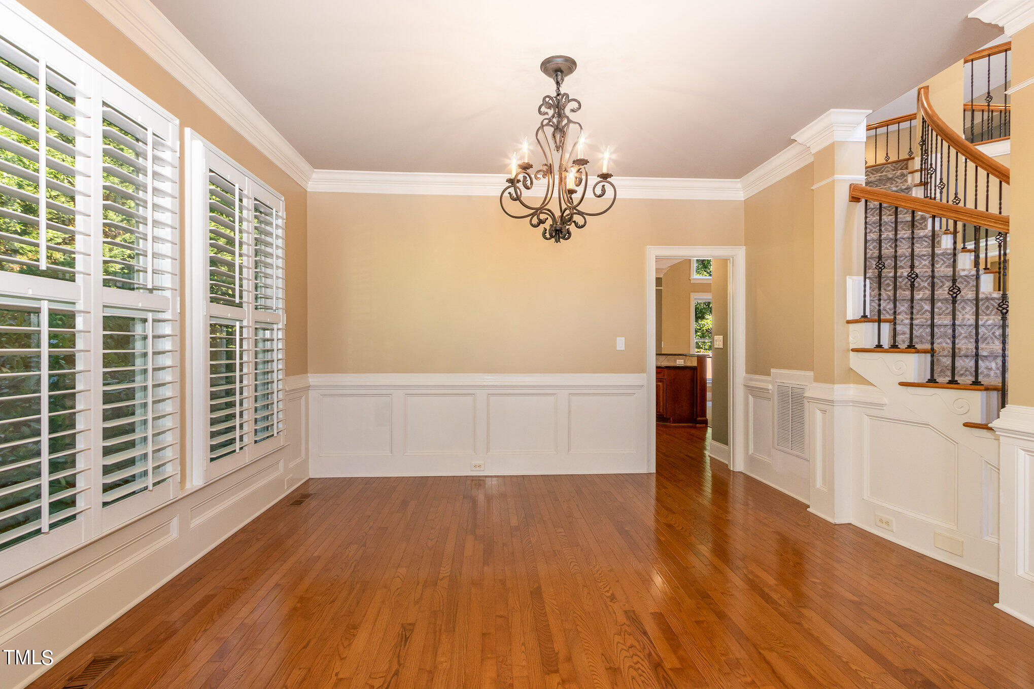 8319 La Matisse Road Raleigh, NC 27615 - Photo 8 of 46 Attractive chair railing and beautiful hardwoods as well as stately columns make this an attractive Dining Room. The doorway leads into the Kitchen.