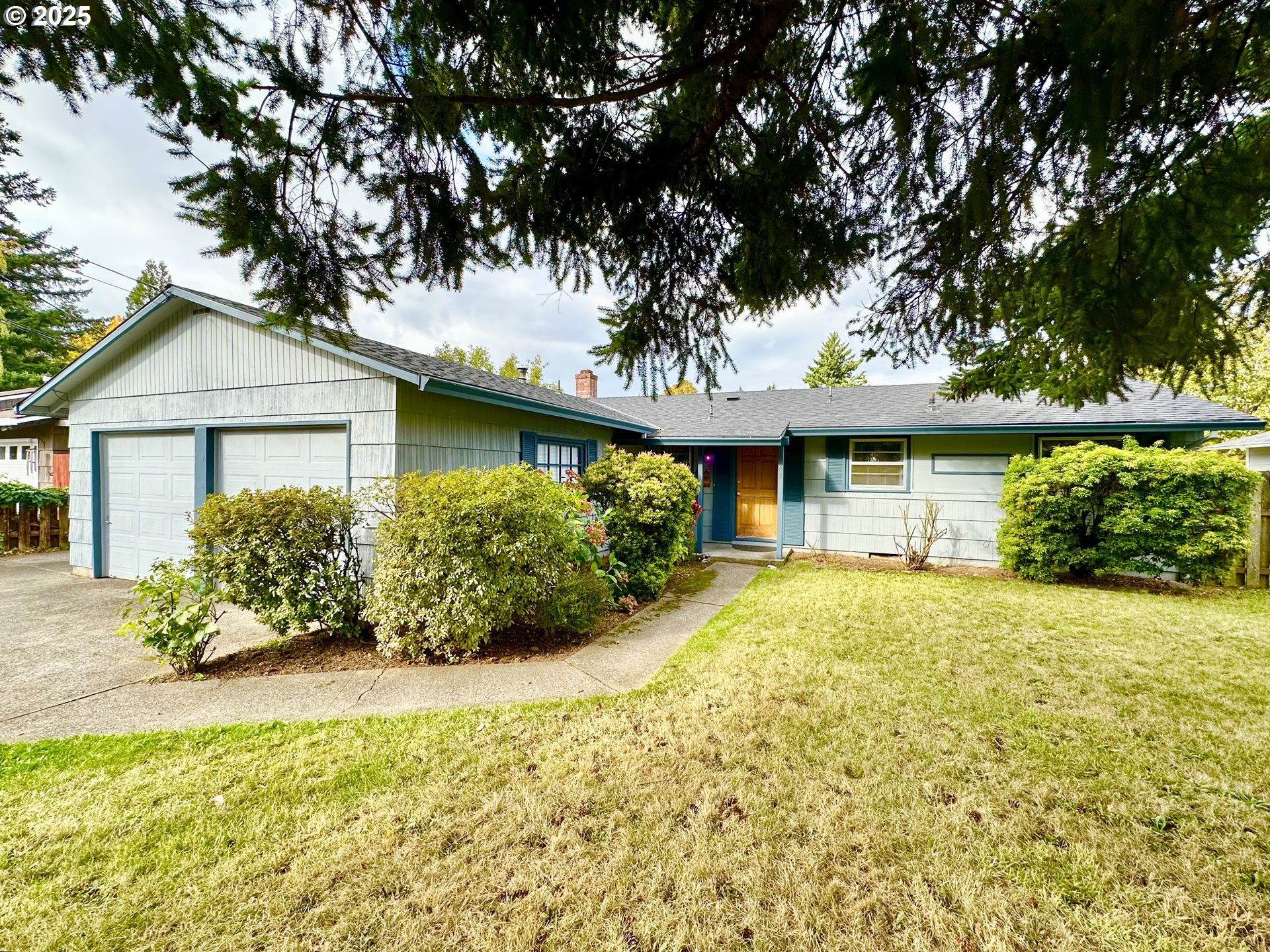 1563 Southeast 11th Street Gresham, OR 97080 - Photo 1 of 30 a front view of a house with a yard and garage