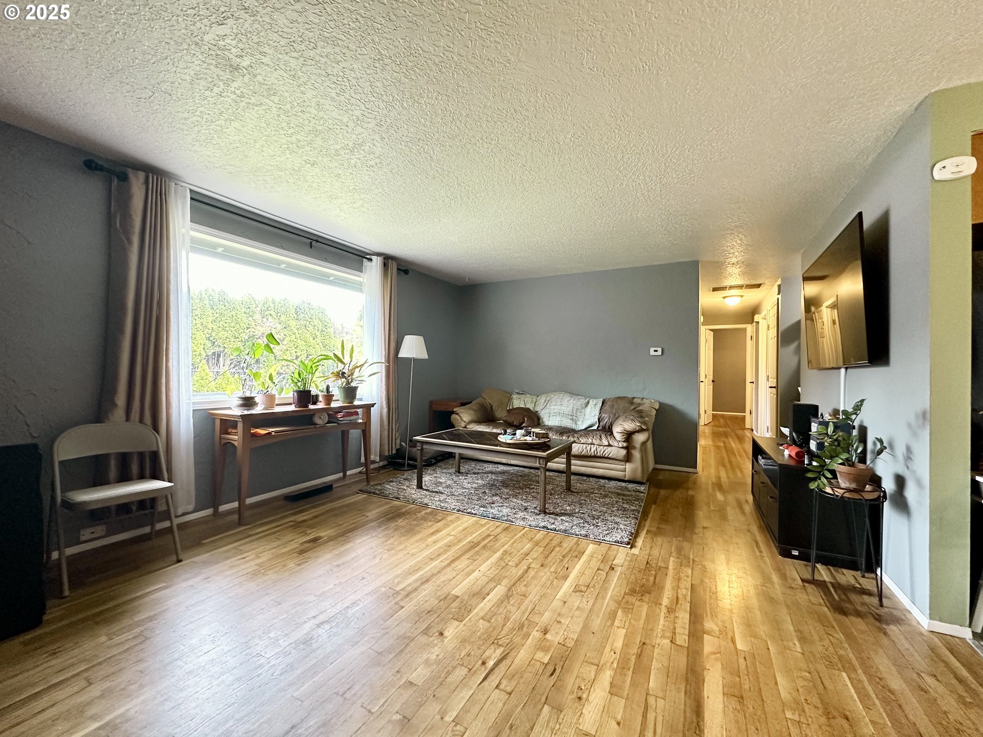 1563 Southeast 11th Street Gresham, OR 97080 - Photo 11 of 30 a living room with furniture and a flat screen tv