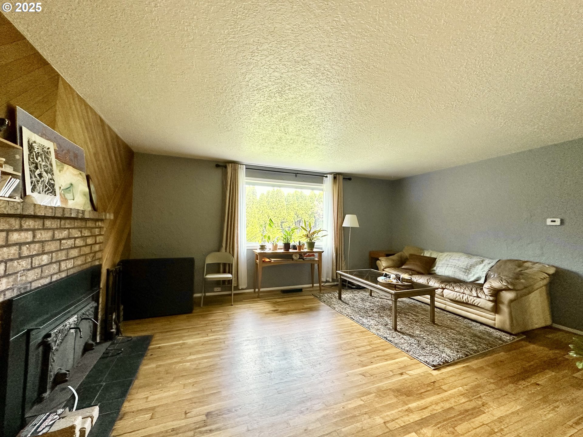 1563 Southeast 11th Street Gresham, OR 97080 - Photo 12 of 30 a living room with furniture stove and a flat screen tv