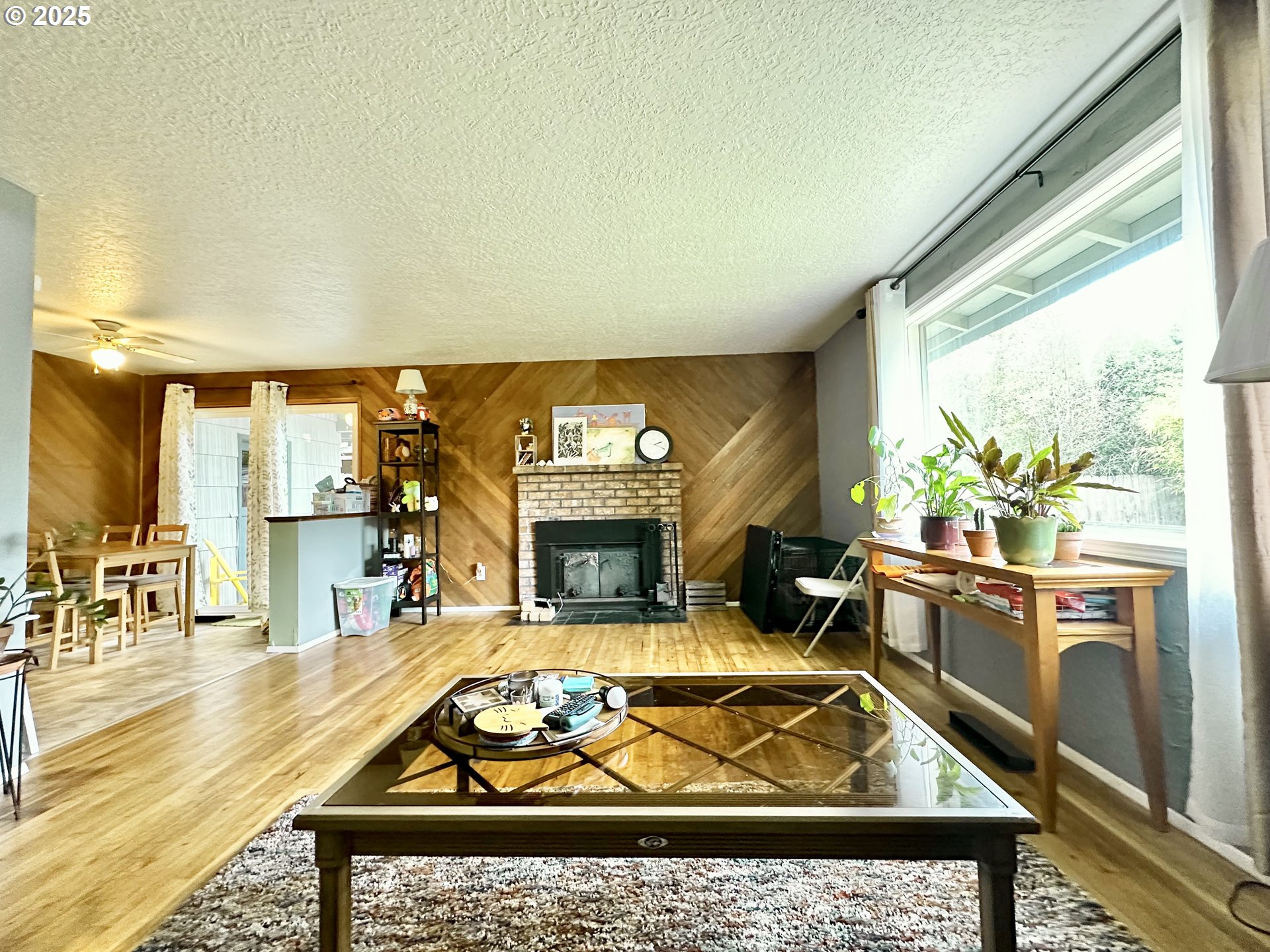 1563 Southeast 11th Street Gresham, OR 97080 - Photo 14 of 30 a living room with furniture a rug and a fireplace