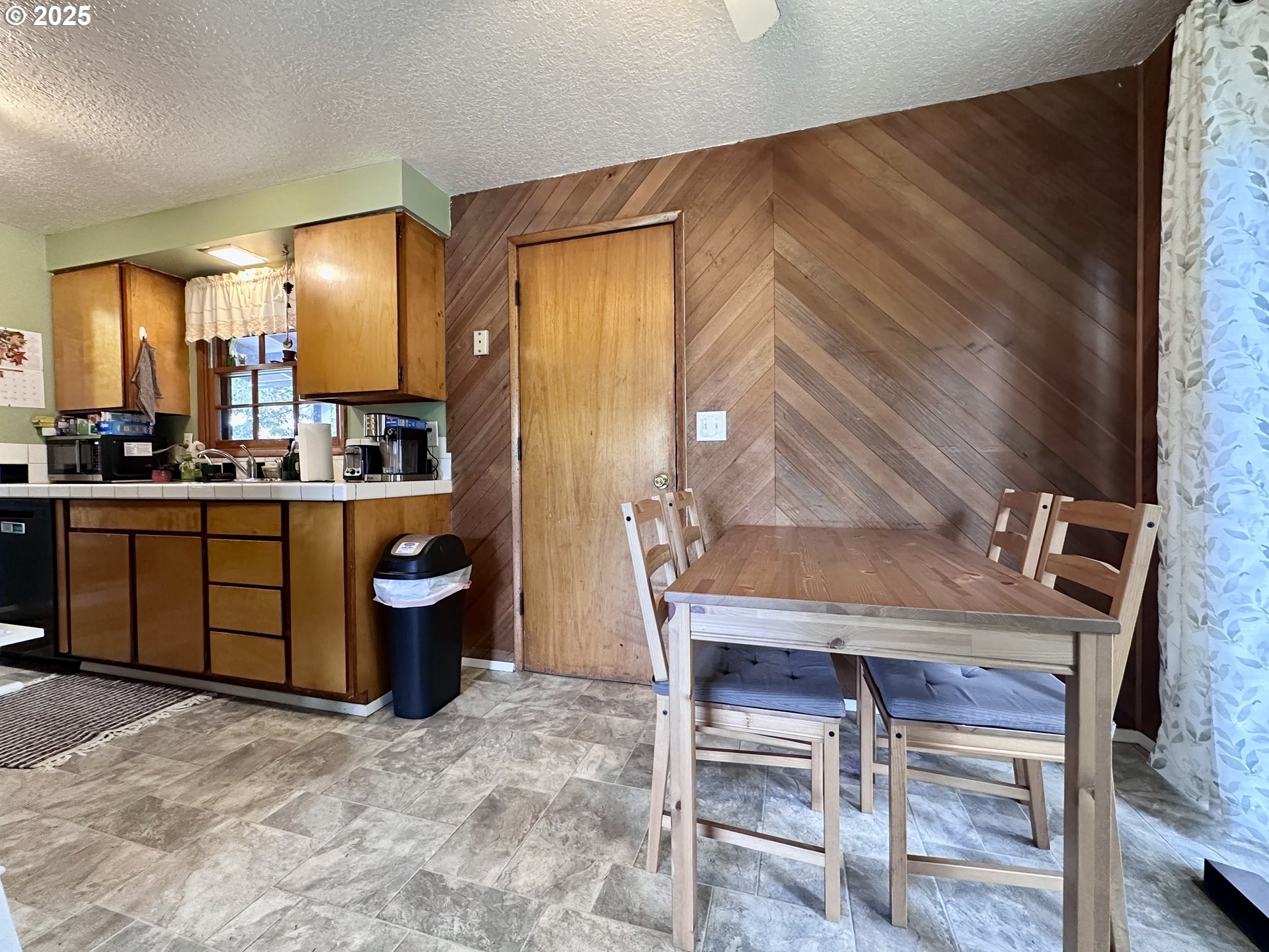 1563 Southeast 11th Street Gresham, OR 97080 - Photo 16 of 30 a room with a table chairs and a kitchen view