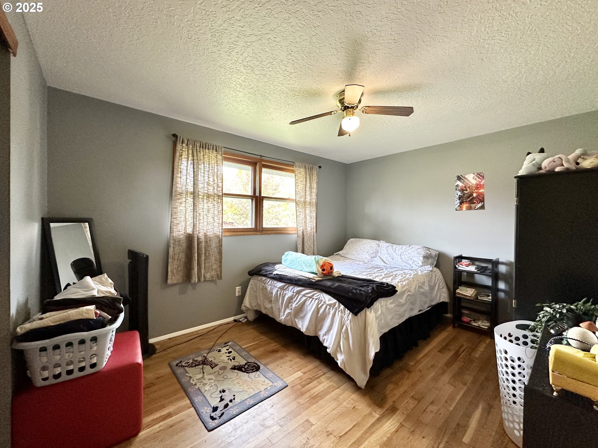 1563 Southeast 11th Street Gresham, OR 97080 - Photo 20 of 30 a bedroom with a bed television and a window