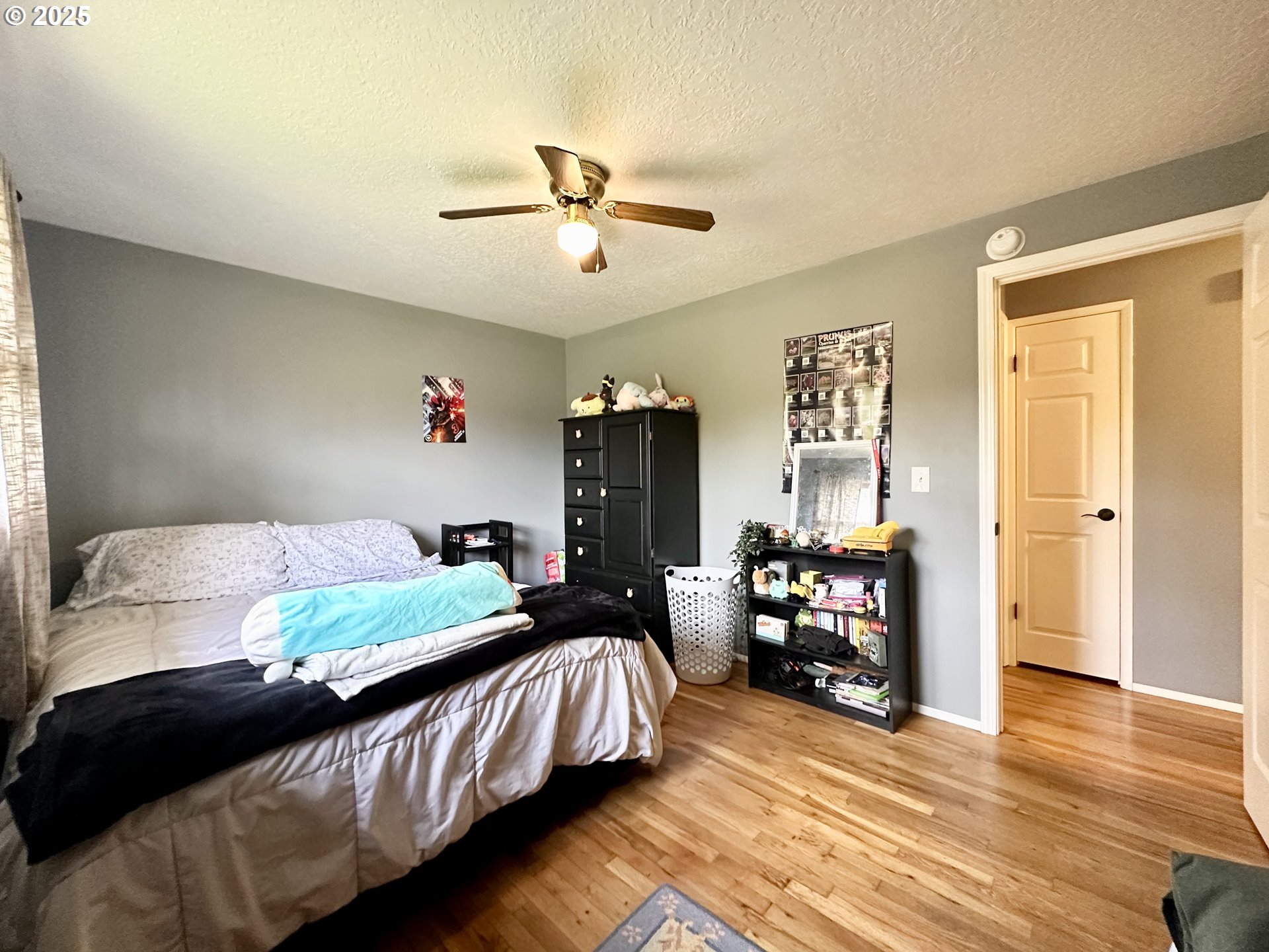 1563 Southeast 11th Street Gresham, OR 97080 - Photo 21 of 30 a bedroom with a bed and wooden floor