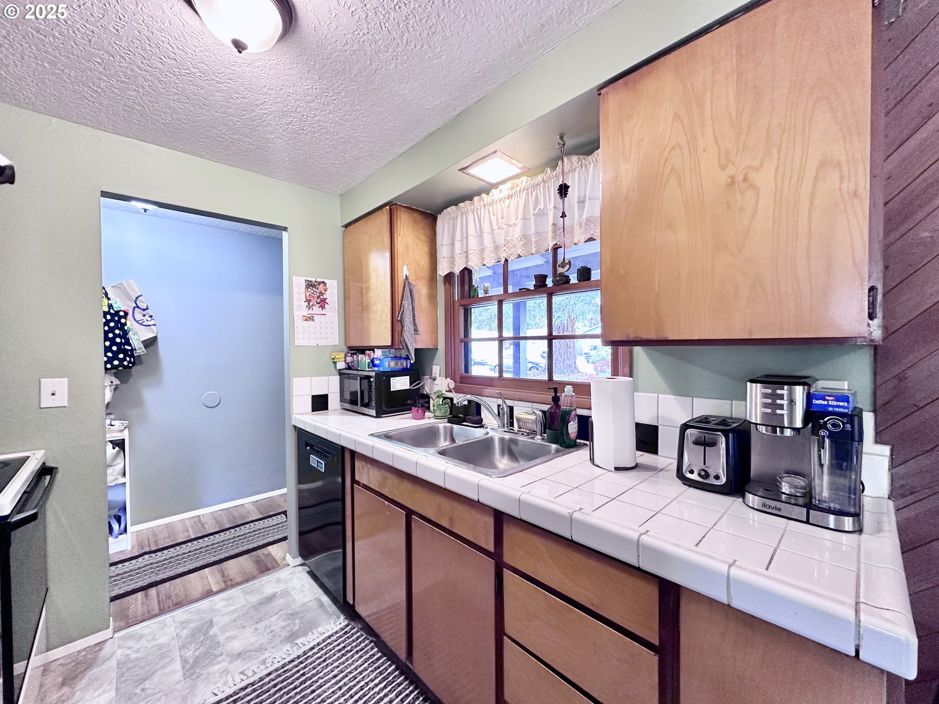 1563 Southeast 11th Street Gresham, OR 97080 - Photo 6 of 30 a kitchen with stainless steel appliances granite countertop a sink stove and cabinets