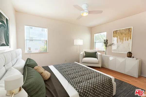 a bedroom with a large bed couch and a window