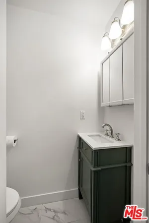 a bathroom with a sink toilet and vanity