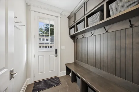 a bedroom with a bed mirror and couch