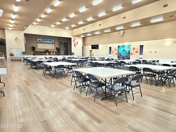 a large dining space with lots of furniture and a large window