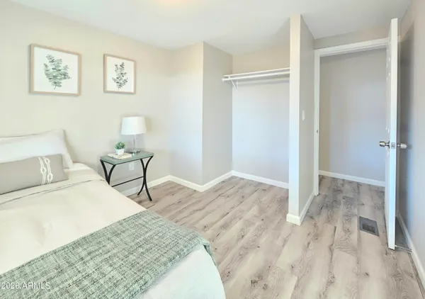 a bedroom with a bed and a lamp on table