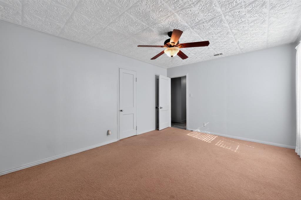 5485 Highway 7 Marlin, TX 76661 - Photo 17 of 36 Unfurnished bedroom with carpet floors, ceiling fan, and an ornate ceiling