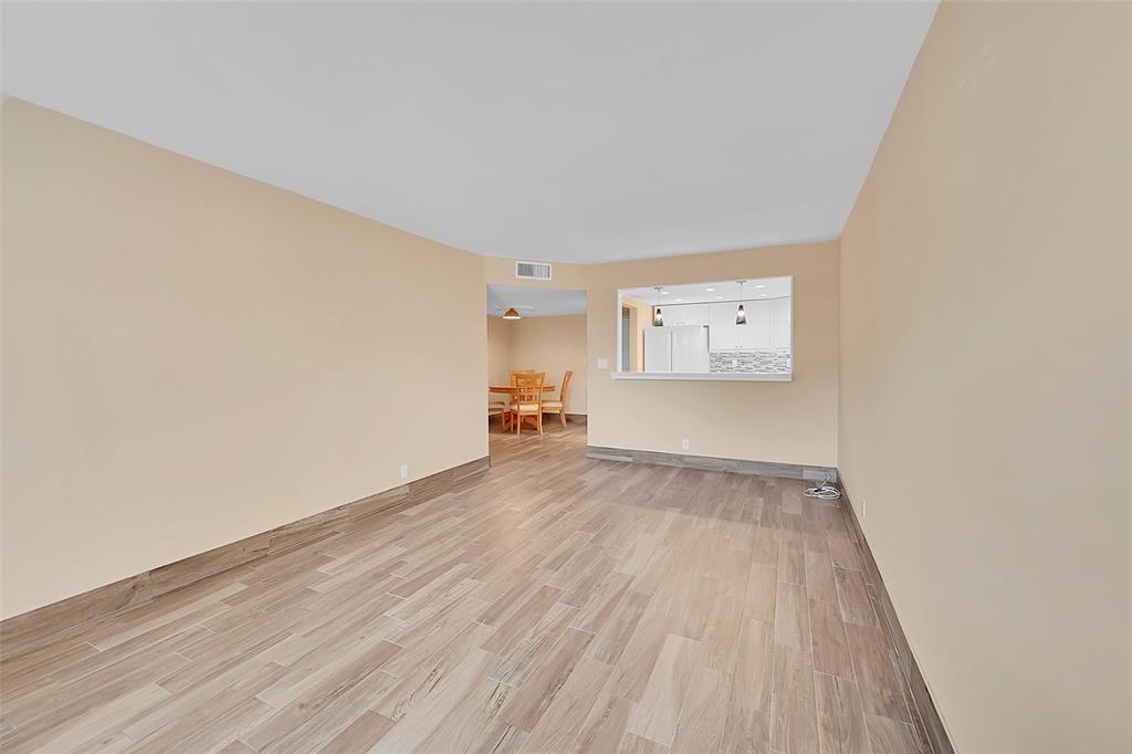 3002 Northeast 5th Terrace, Unit 102B Wilton Manors, FL 33334 - Photo 11 of 44 a view of empty room with wooden floor