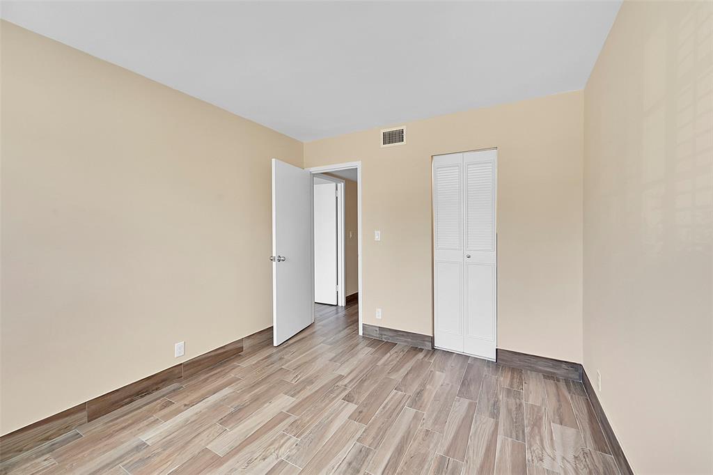 3002 Northeast 5th Terrace, Unit 102B Wilton Manors, FL 33334 - Photo 23 of 44 a view of a room with wooden floor