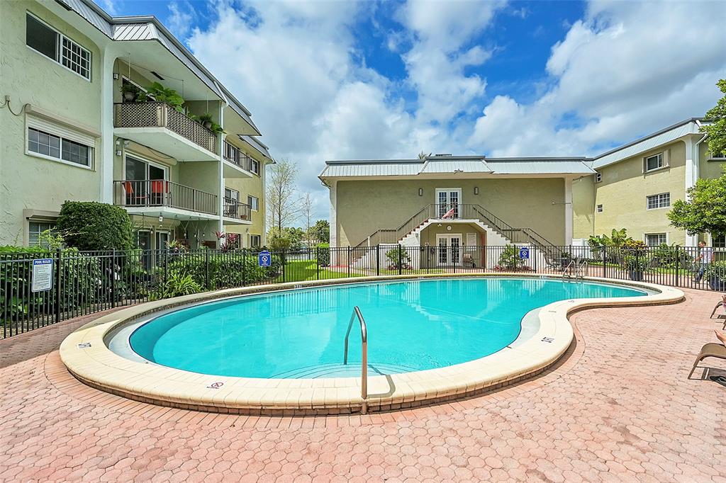 3002 Northeast 5th Terrace, Unit 102B Wilton Manors, FL 33334 - Photo 31 of 44 a view of outdoor space yard swimming pool and porch