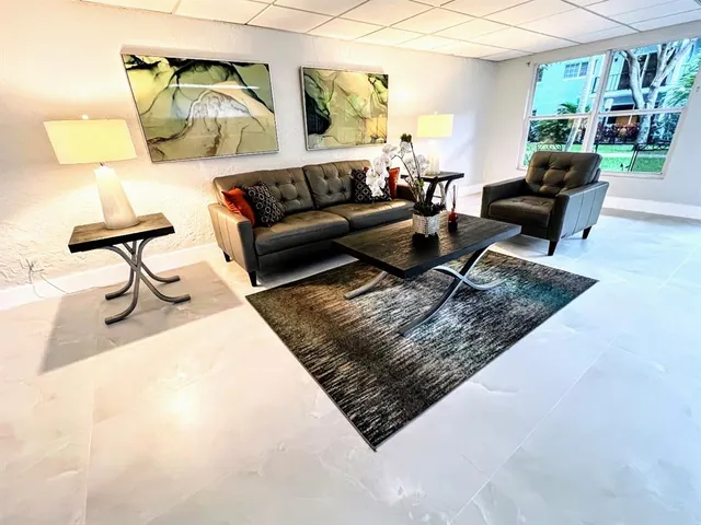 a living room with furniture and a rug