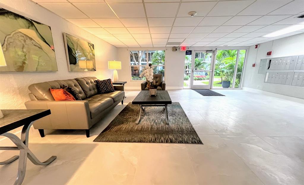 3002 Northeast 5th Terrace, Unit 102B Wilton Manors, FL 33334 - Photo 36 of 44 a living room with furniture and a large window