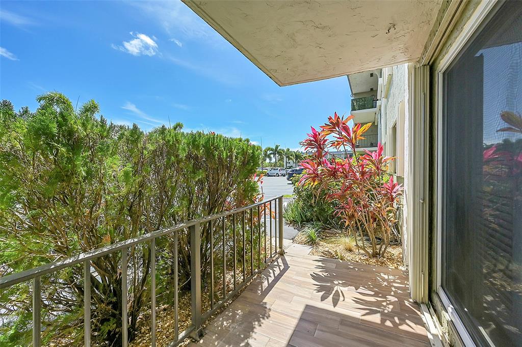 3002 Northeast 5th Terrace, Unit 102B Wilton Manors, FL 33334 - Photo 7 of 44 a view of a balcony with flower plants