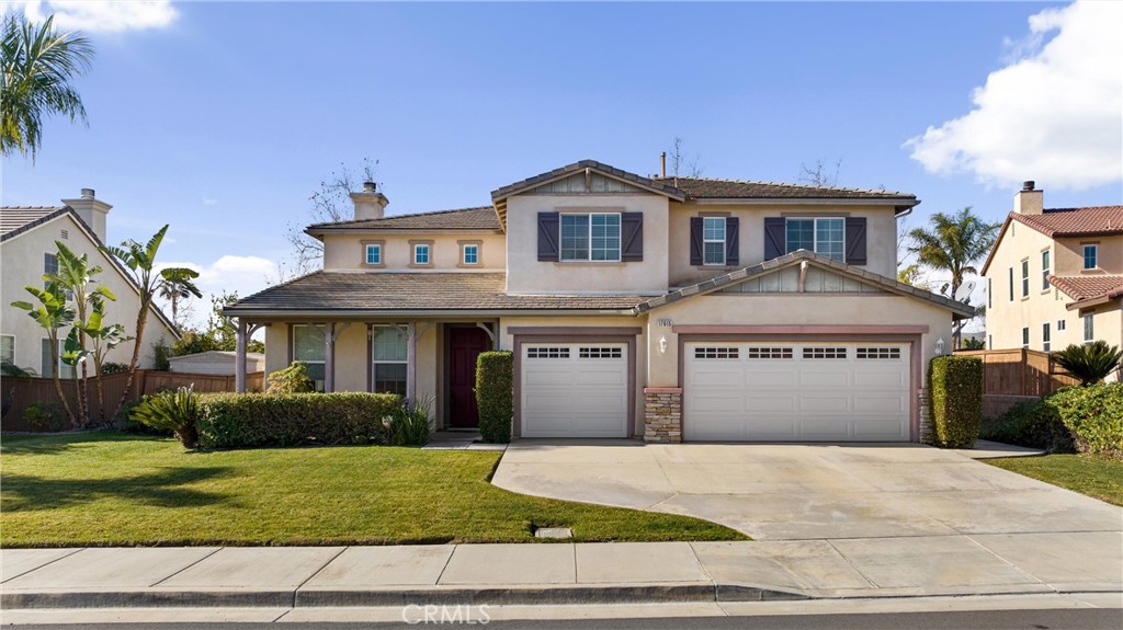 17615 Fan Palm Lane Riverside, CA 92503 - Photo 1 of 1 a front view of a house with a yard and garage