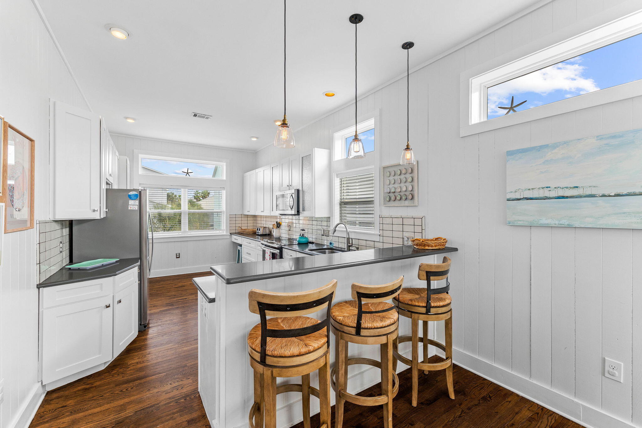 49 Sandy Lane Santa Rosa Beach, FL 32459 - Photo 10 of 73 a kitchen with granite countertop a sink a stove and chairs