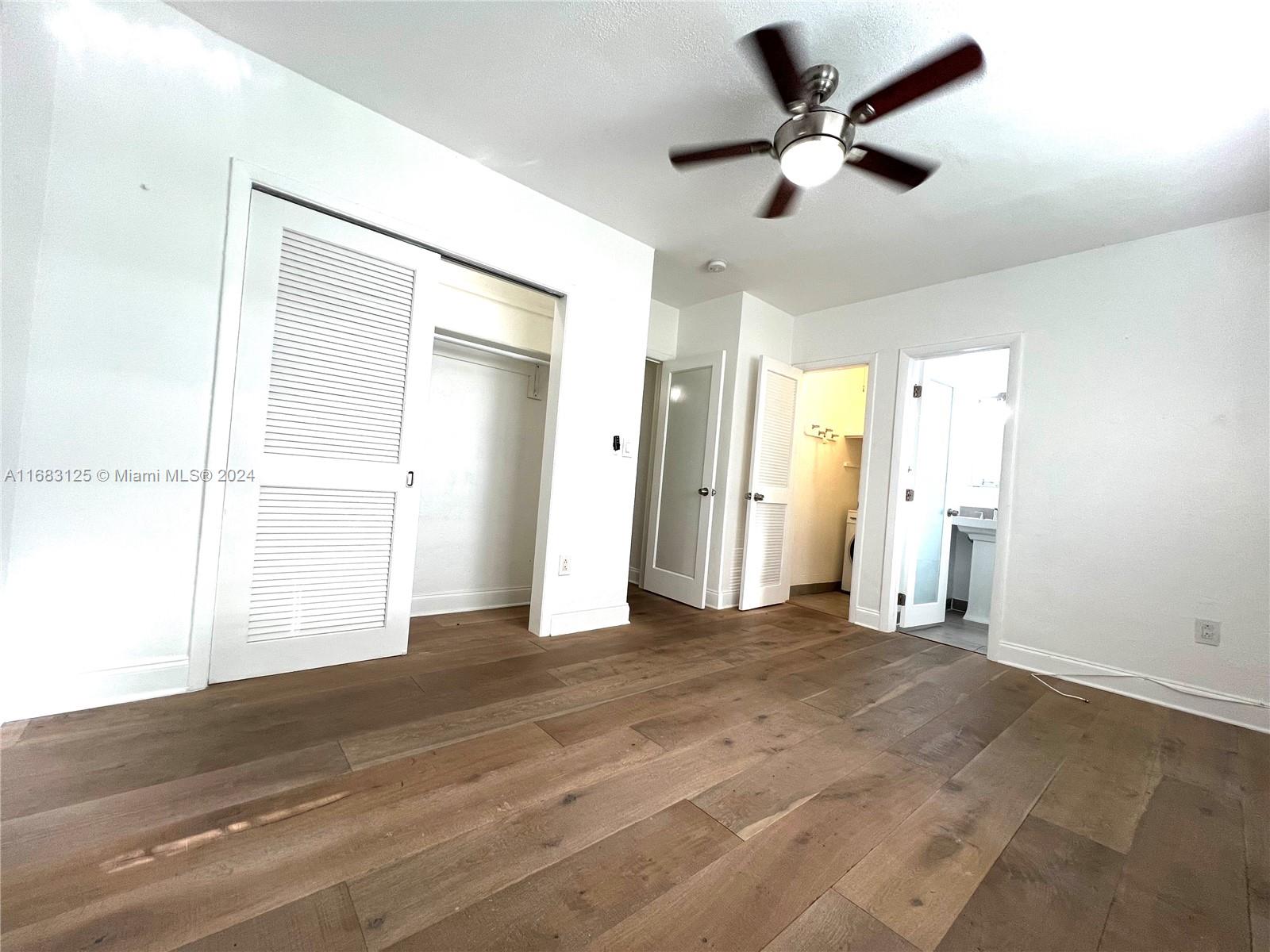 541 Northeast 63rd Street, Unit 3 Miami, FL 33138 - Photo 11 of 19 a view of empty room with wooden floor and fan