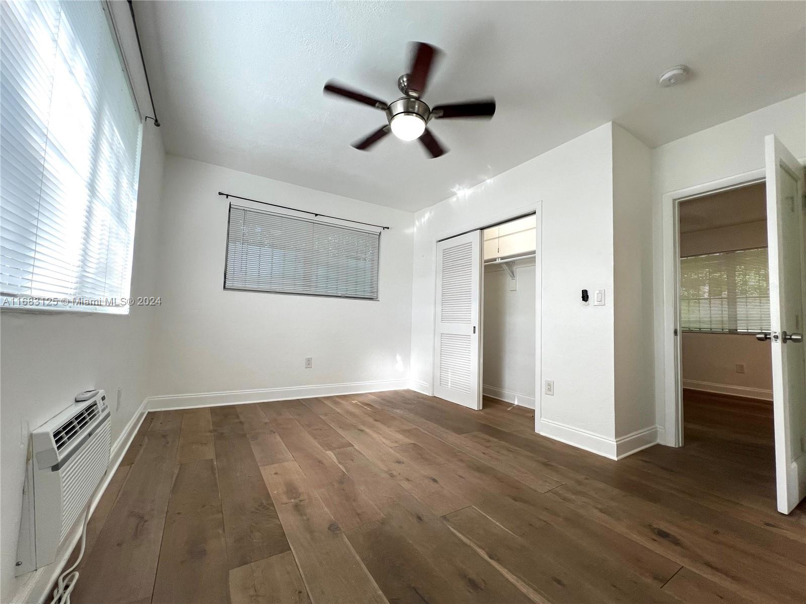 541 Northeast 63rd Street, Unit 3 Miami, FL 33138 - Photo 12 of 19 wooden floor in an empty room with a window