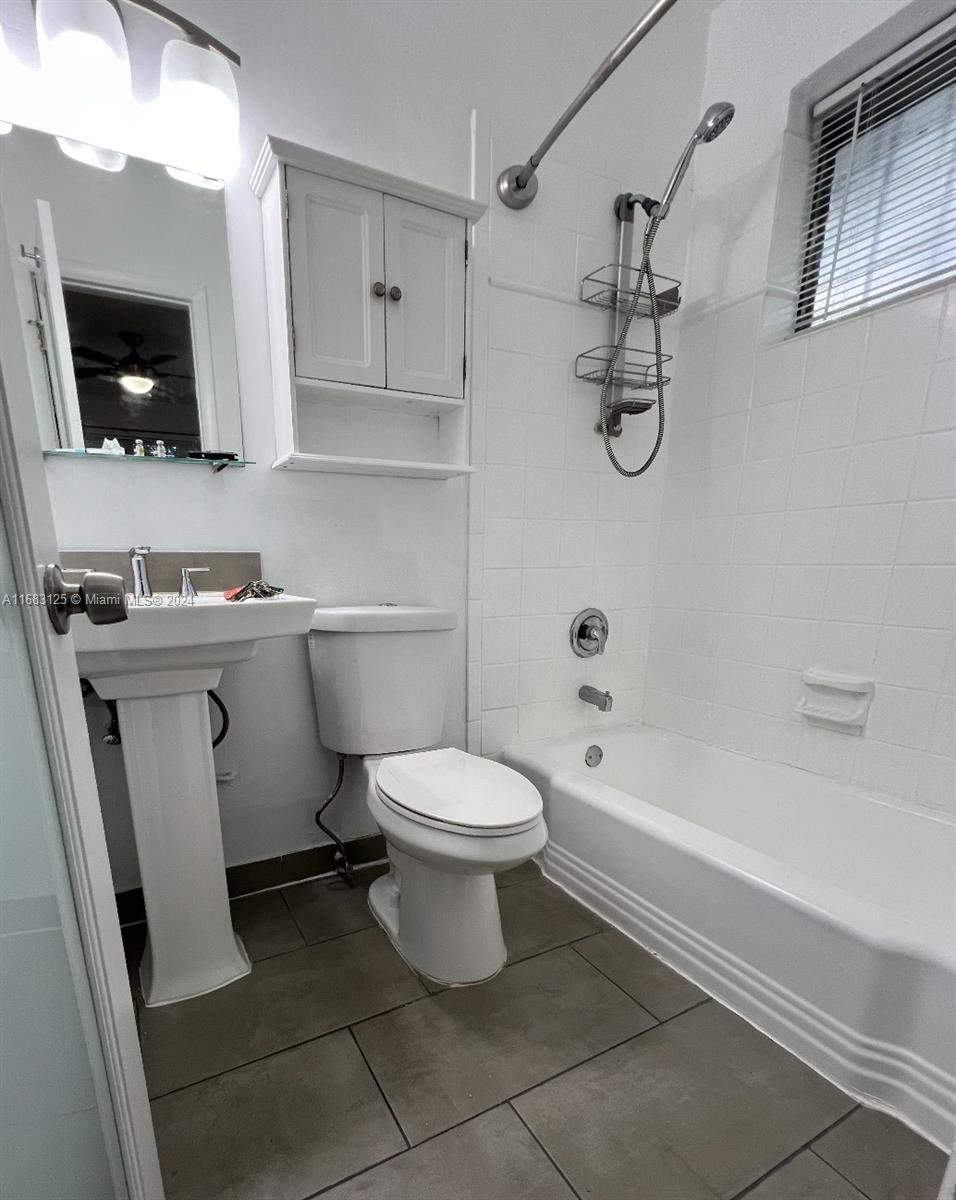 541 Northeast 63rd Street, Unit 3 Miami, FL 33138 - Photo 14 of 19 a bathroom with a sink a toilet and shower