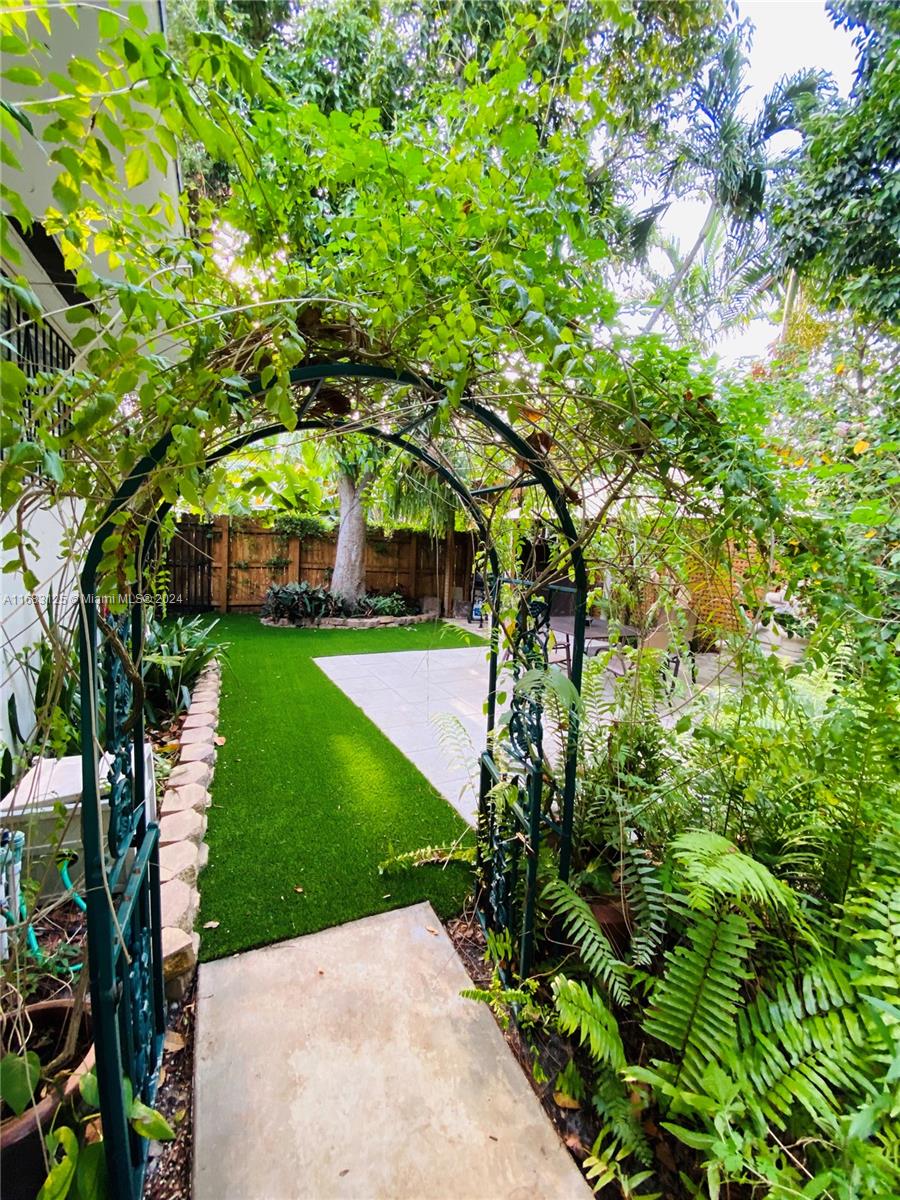 541 Northeast 63rd Street, Unit 3 Miami, FL 33138 - Photo 16 of 19 a view of a yard with plants and large trees