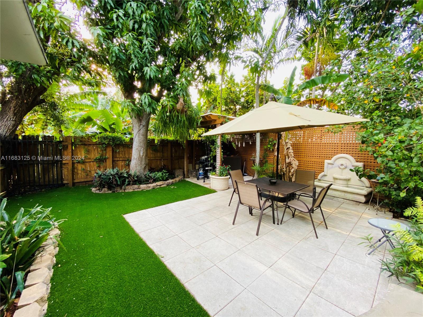 541 Northeast 63rd Street, Unit 3 Miami, FL 33138 - Photo 19 of 19 a view of a house with backyard sitting area and garden