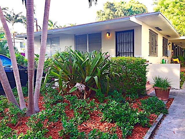 541 Northeast 63rd Street, Unit 3 Miami, FL 33138 - Photo 4 of 19 a view of a house with a flower garden