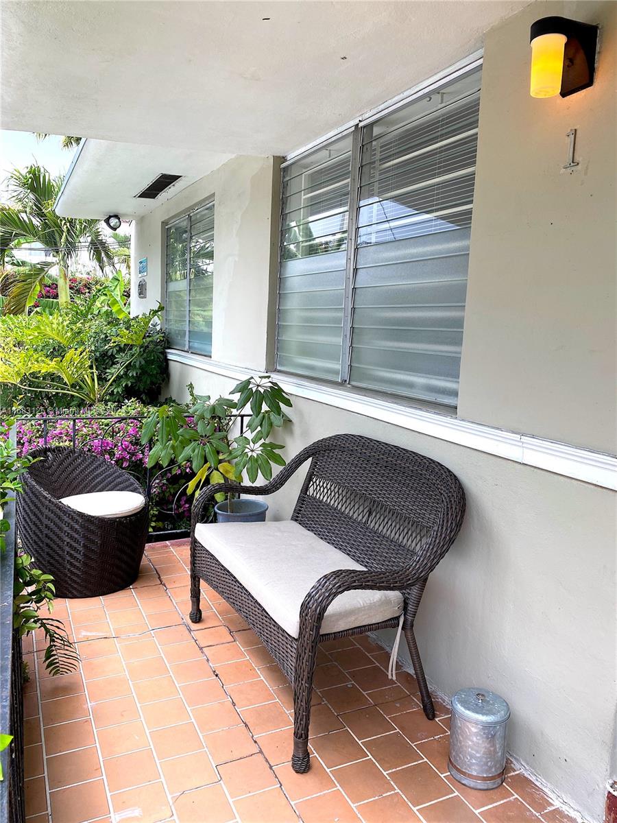 541 Northeast 63rd Street, Unit 3 Miami, FL 33138 - Photo 6 of 19 a view of a chair and table in back yard of the house