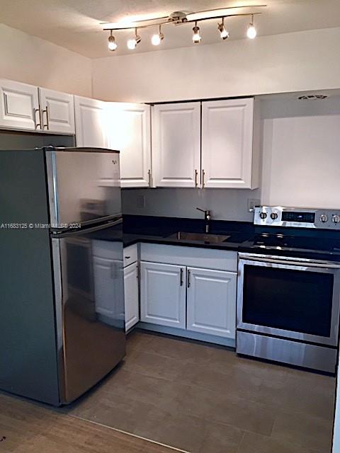 541 Northeast 63rd Street, Unit 3 Miami, FL 33138 - Photo 8 of 19 a kitchen with granite countertop a sink and stainless steel appliances