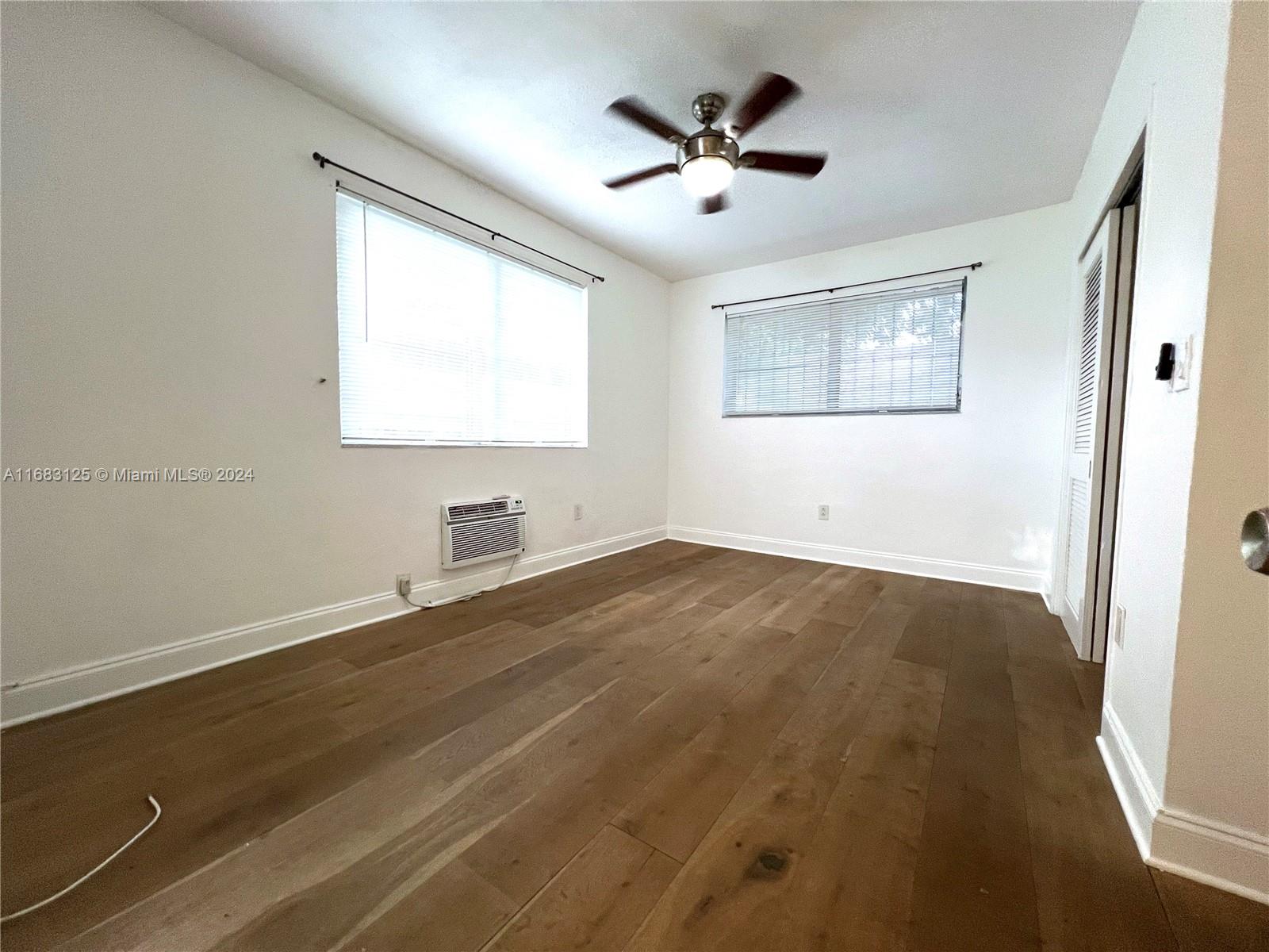 541 Northeast 63rd Street, Unit 3 Miami, FL 33138 - Photo 10 of 19 an empty room with a window and a ceiling fan