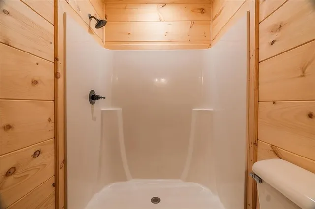a bathroom with a shower toilet and sink